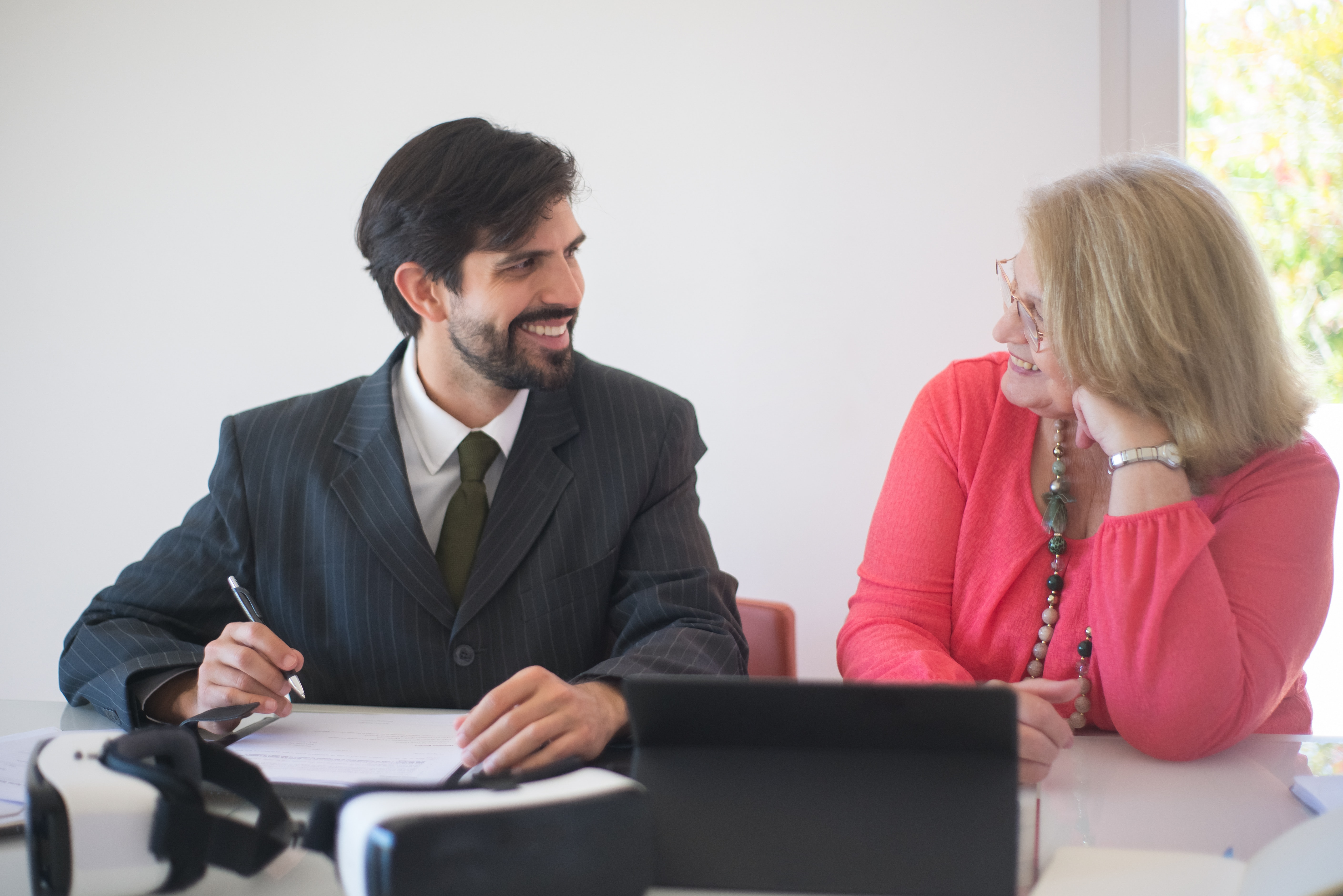 Photo of two people signing a contract